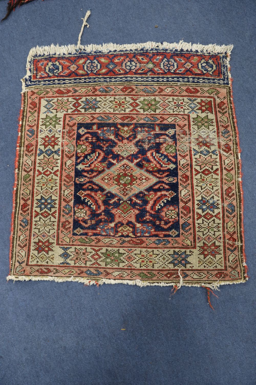 Two Afghan salt bags, a similar saddle bag and a Caucasian rug (4)